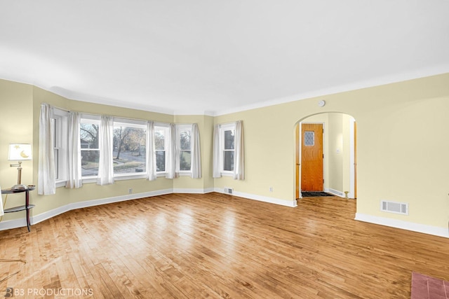 unfurnished room with light wood-type flooring