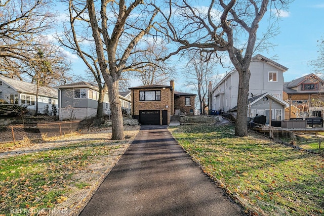 view of front facade with a garage and a front lawn