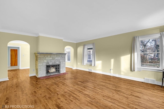 unfurnished living room with hardwood / wood-style floors and ornamental molding