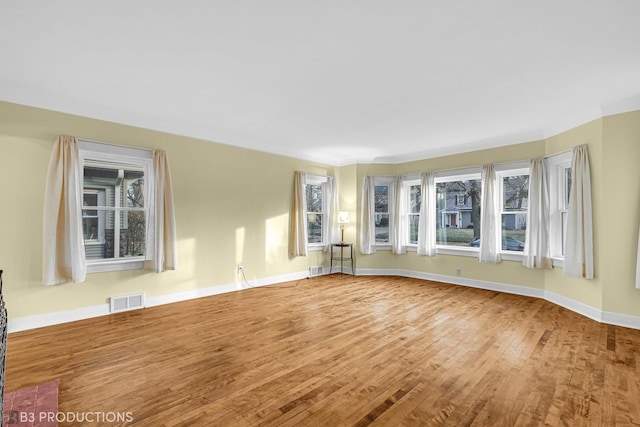 unfurnished room with wood-type flooring