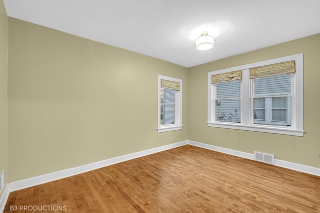 empty room with hardwood / wood-style floors