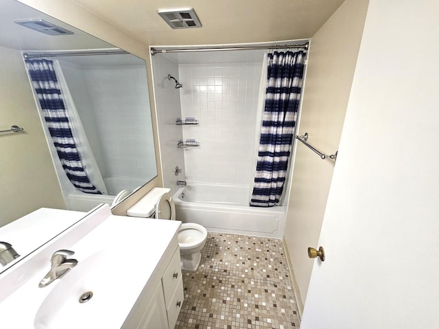 full bathroom with vanity, shower / tub combo, and toilet