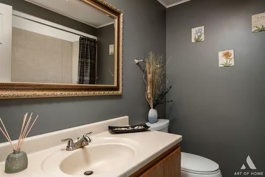 bathroom featuring vanity and toilet