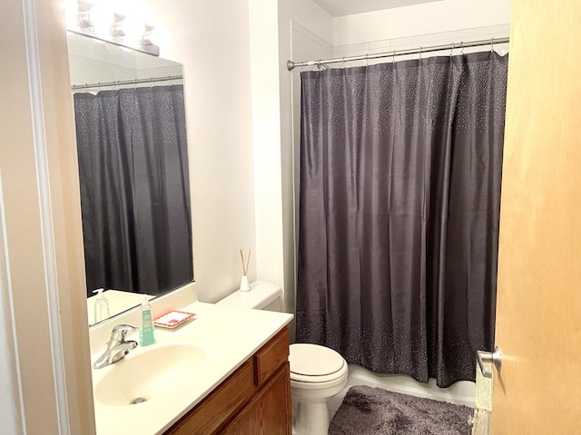 bathroom with vanity, toilet, and a shower with shower curtain