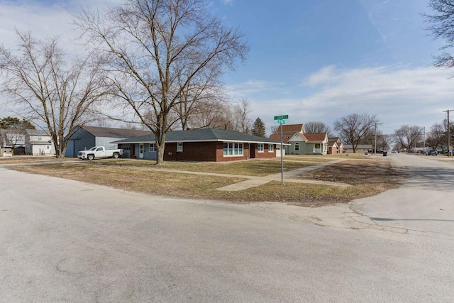 view of front of property with brick siding and a front lawn