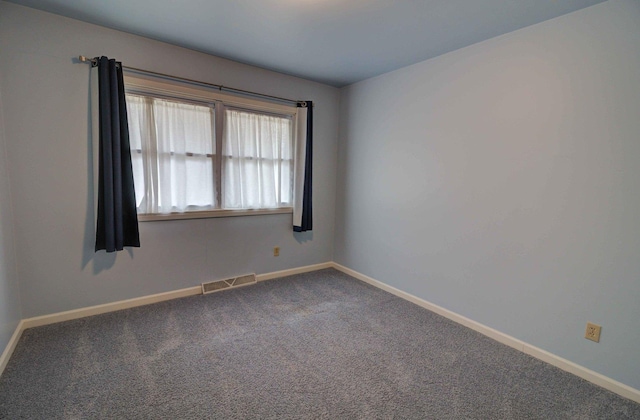 carpeted empty room with visible vents and baseboards