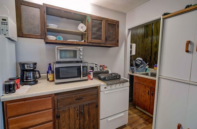 kitchen featuring electric stove, dark wood-style floors, stainless steel microwave, light countertops, and open shelves