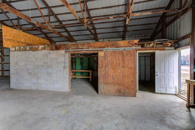 garage featuring concrete block wall and metal wall