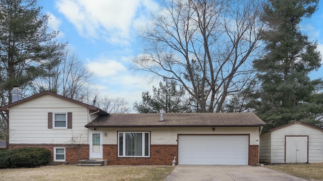 tri-level home featuring a storage shed, concrete driveway, an attached garage, an outdoor structure, and a front lawn