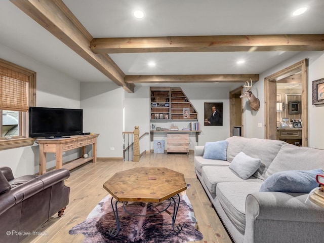 living room with light hardwood / wood-style flooring and beamed ceiling