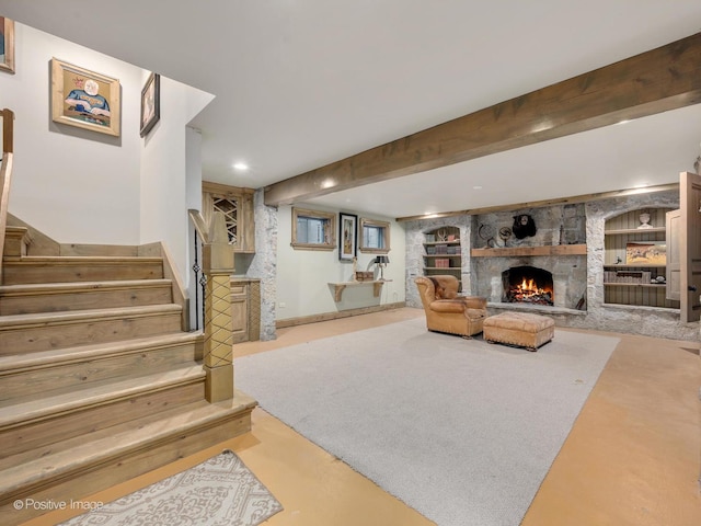 living room with beam ceiling and a stone fireplace