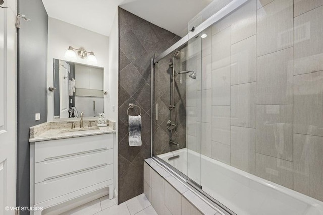 bathroom featuring vanity, tile patterned flooring, and enclosed tub / shower combo