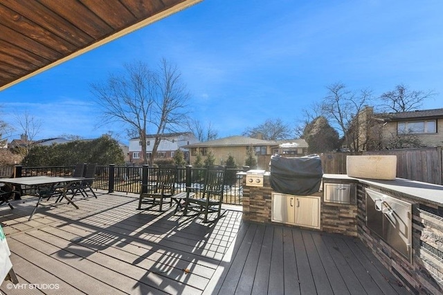 wooden terrace featuring area for grilling