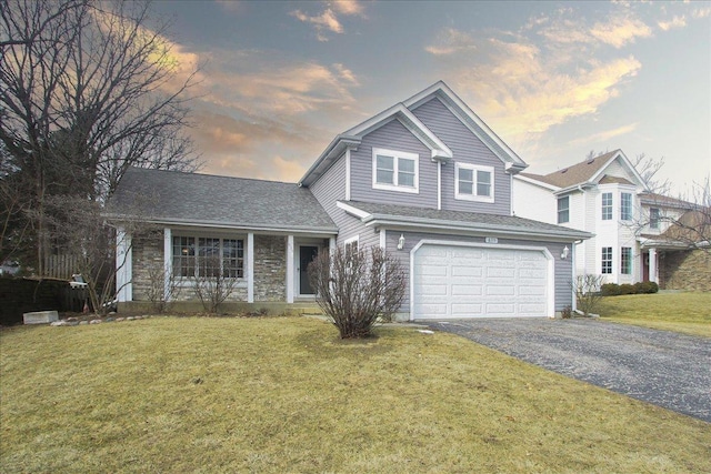 view of front of house featuring a garage and a lawn