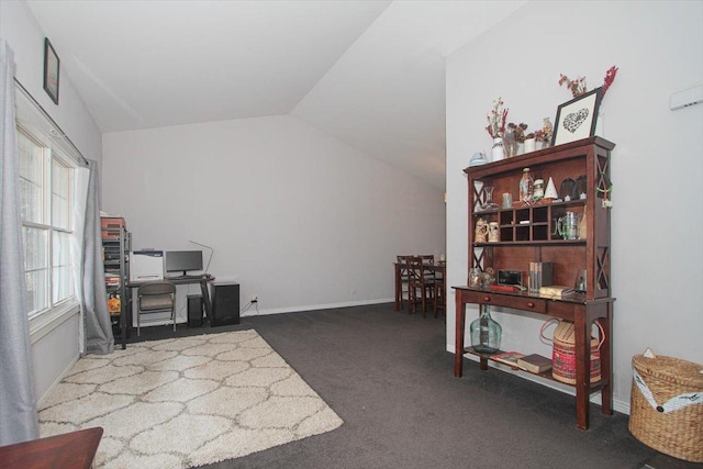 carpeted office featuring vaulted ceiling