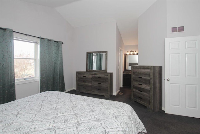 carpeted bedroom with lofted ceiling