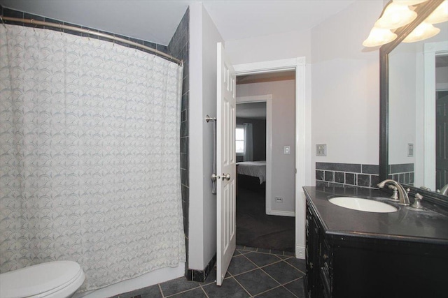 bathroom featuring tile patterned flooring, vanity, and toilet