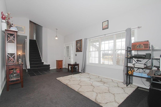 carpeted entrance foyer with vaulted ceiling