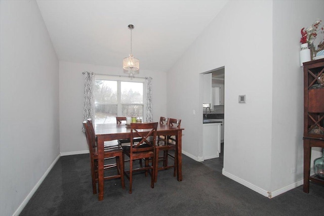 dining room featuring dark carpet, sink, and vaulted ceiling