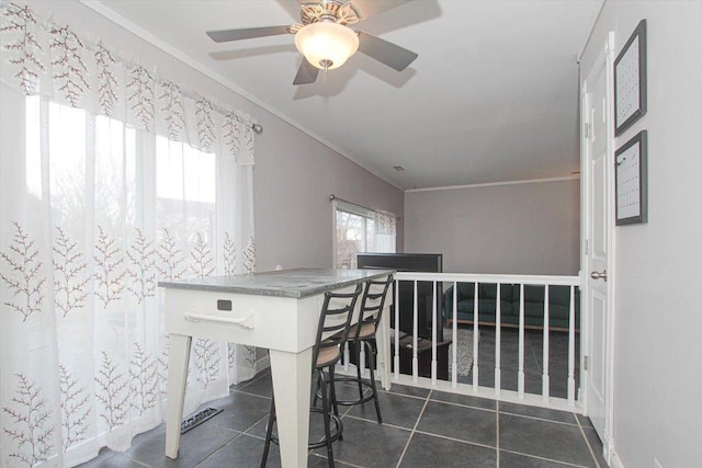 tiled dining room featuring ornamental molding