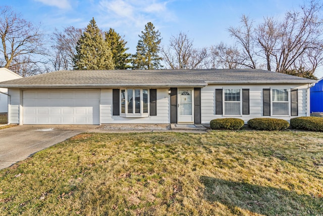 ranch-style home featuring an attached garage, concrete driveway, and a front yard