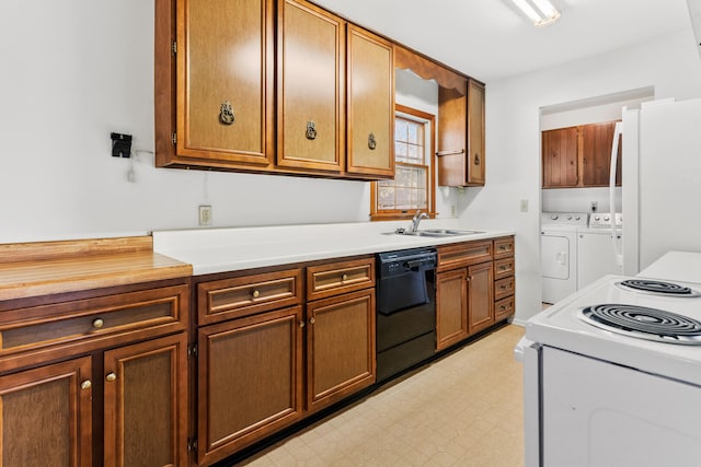 kitchen with white appliances, light floors, washing machine and clothes dryer, a sink, and light countertops