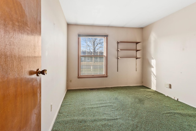 carpeted spare room with baseboards