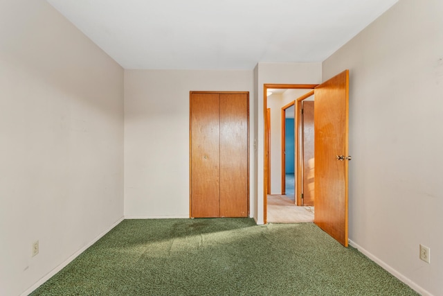 unfurnished bedroom featuring a closet, baseboards, and carpet floors