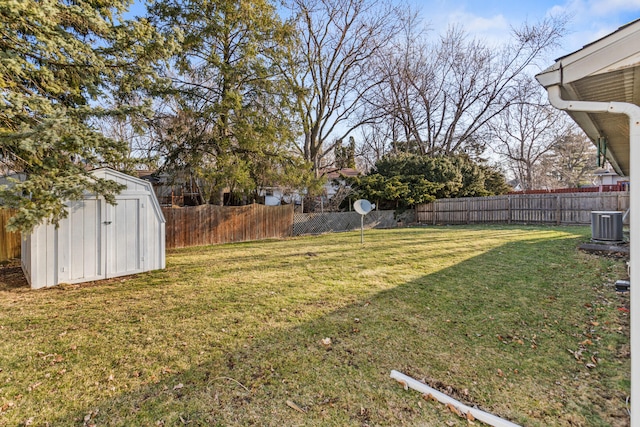 view of yard featuring a fenced backyard, an outdoor structure, and a shed