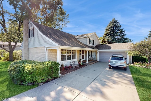 view of front facade with brick siding, a front lawn, concrete driveway, a chimney, and an attached garage