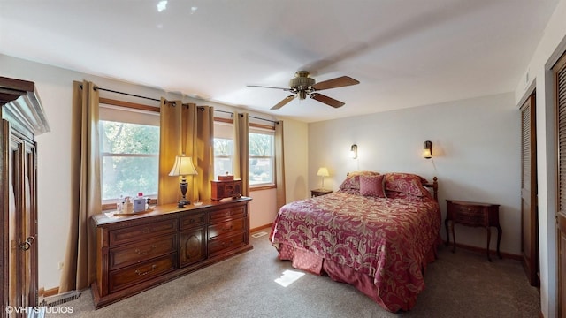 bedroom featuring ceiling fan, baseboards, and light carpet