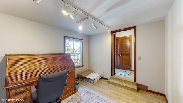 office space with light wood-style flooring and baseboards