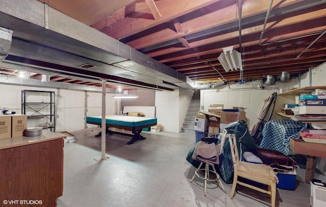 unfinished basement featuring stairway and pool table
