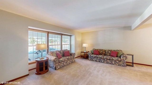 carpeted living area with baseboards