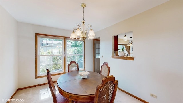 dining area with a chandelier, light colored carpet, and baseboards