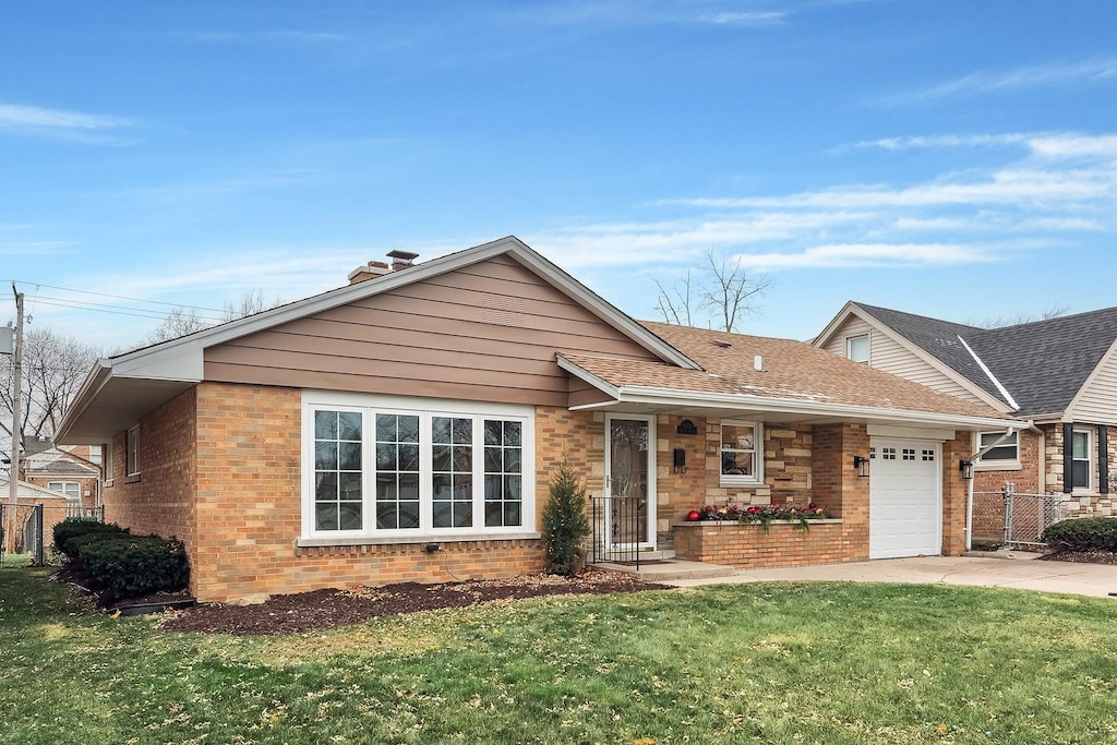 ranch-style home with a garage and a front lawn