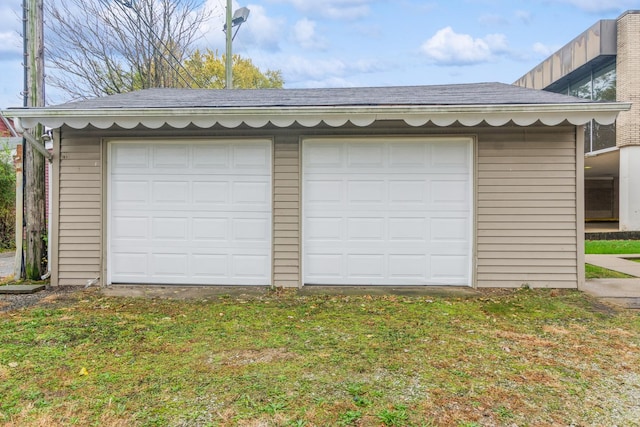 garage featuring a lawn