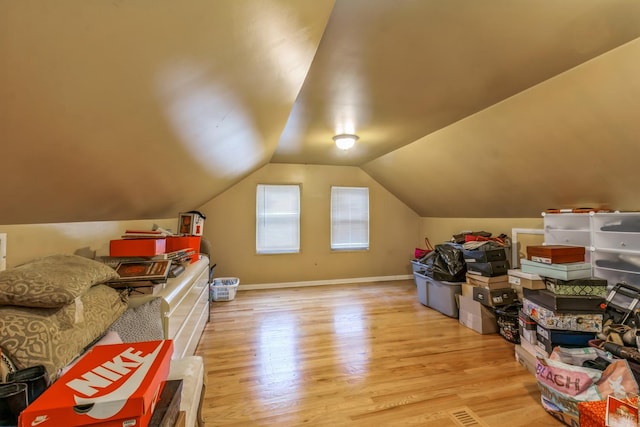 additional living space with lofted ceiling and light hardwood / wood-style flooring