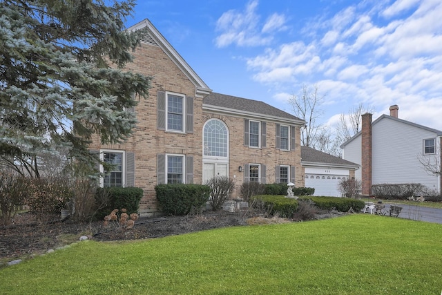 view of front facade featuring a garage and a front lawn