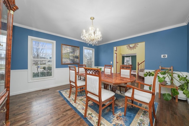 dining space with ornamental molding, dark hardwood / wood-style floors, and a chandelier