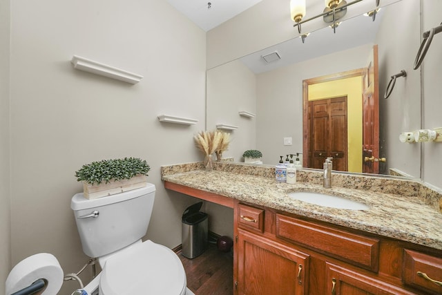 bathroom featuring hardwood / wood-style flooring, vanity, and toilet