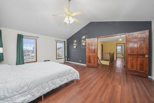 bedroom with ceiling fan, lofted ceiling, dark hardwood / wood-style floors, and multiple windows