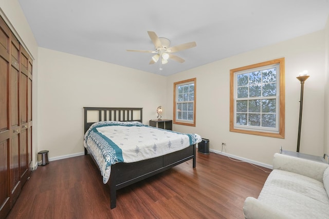 bedroom with ceiling fan, dark hardwood / wood-style floors, and a closet