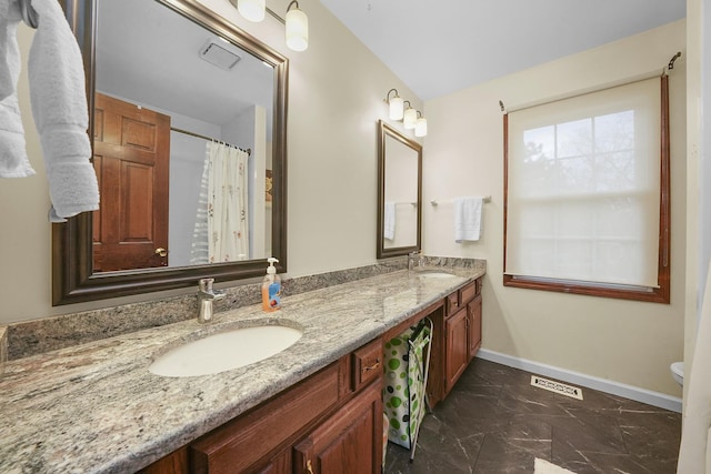 bathroom featuring vanity and toilet