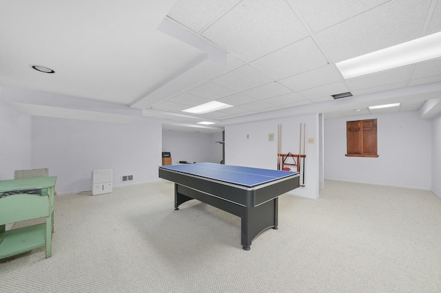 recreation room with light carpet and a paneled ceiling