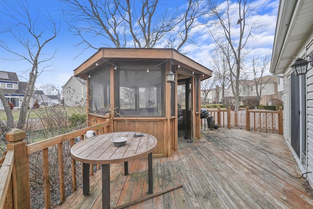 wooden deck with a sunroom