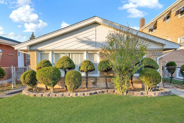 view of side of property with a lawn