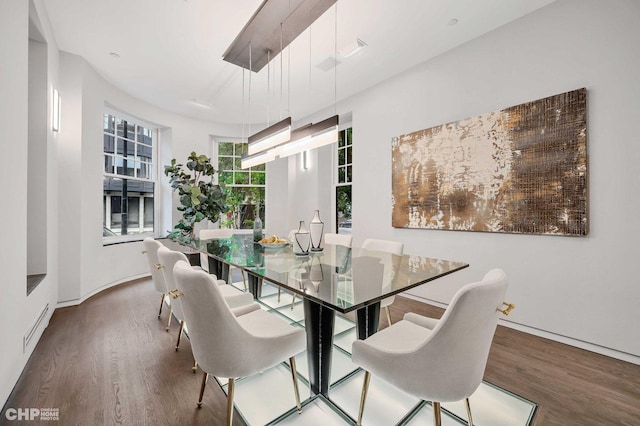 dining space with wood-type flooring