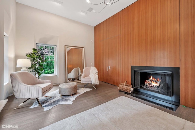 living area featuring dark wood-type flooring and a towering ceiling