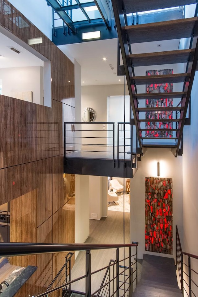 stairs featuring hardwood / wood-style floors